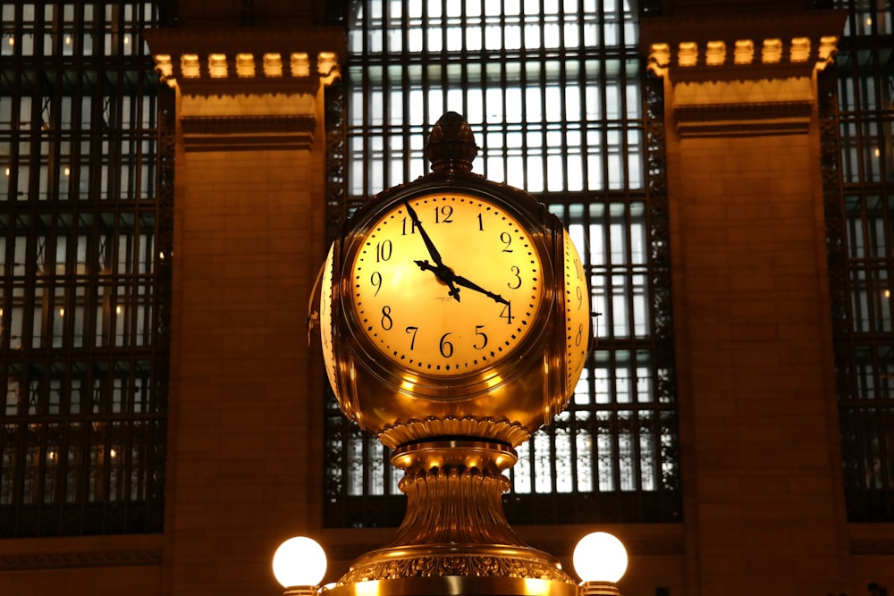 a clock in a train station at night