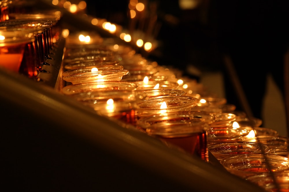 a row of lit candles sitting next to each other