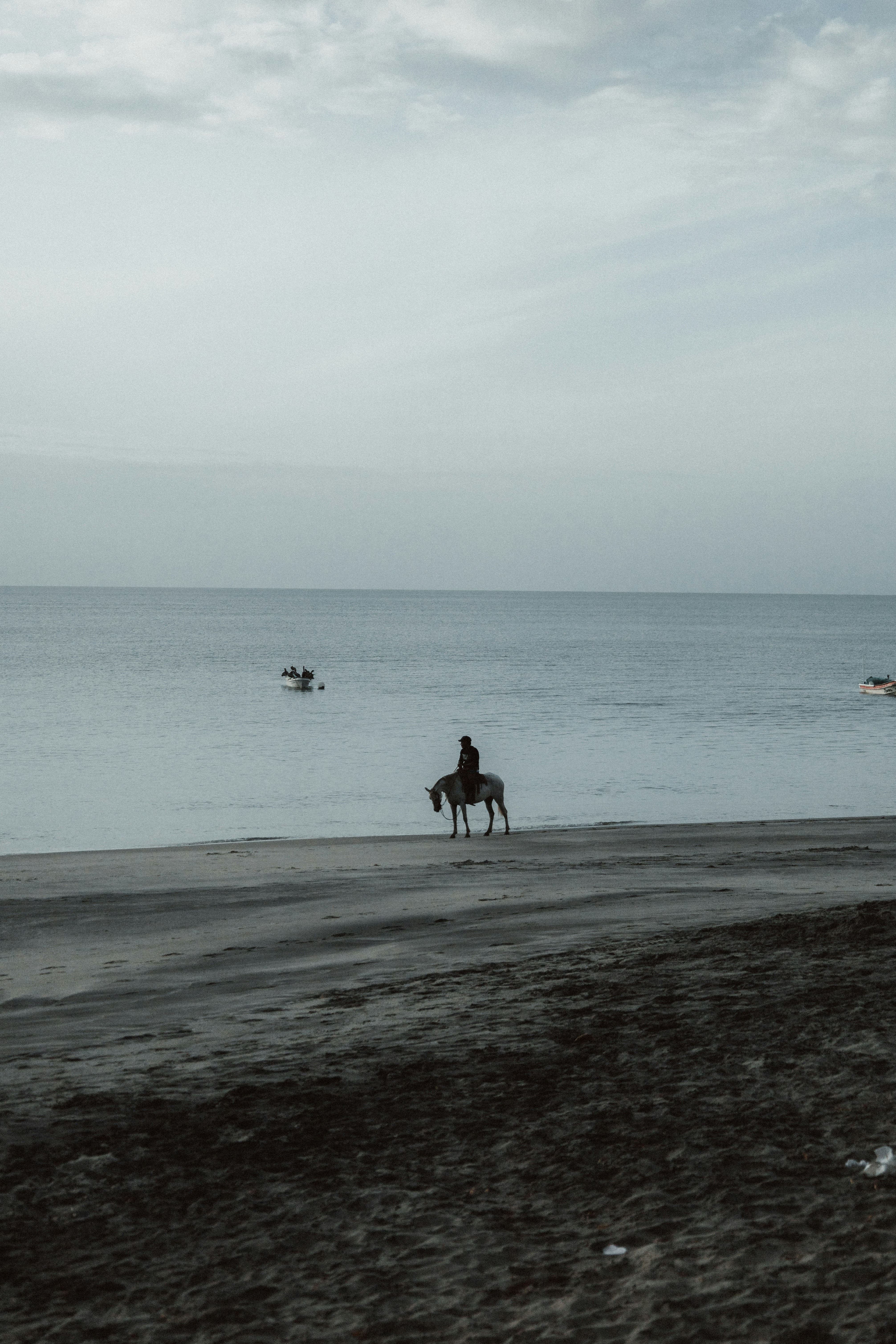 a person riding a horse on a beach
