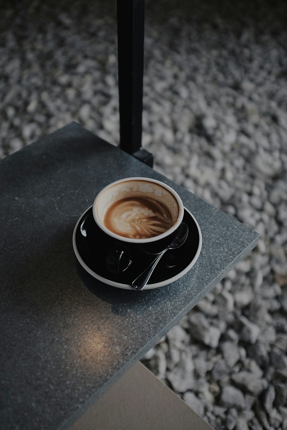 a cup of coffee sitting on top of a table