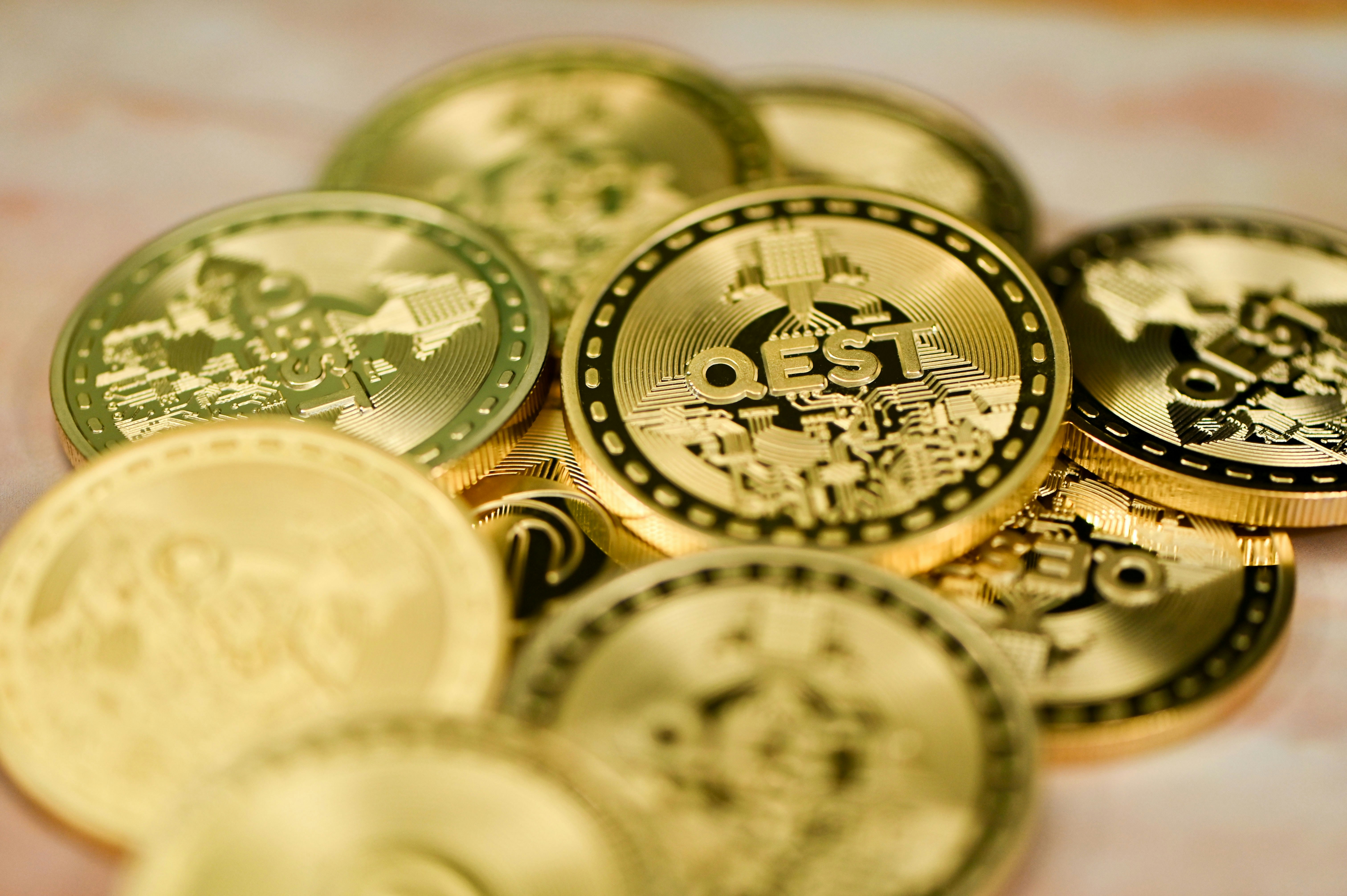 a pile of gold and silver coins sitting on top of a table