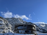 a building in the middle of a snowy mountain