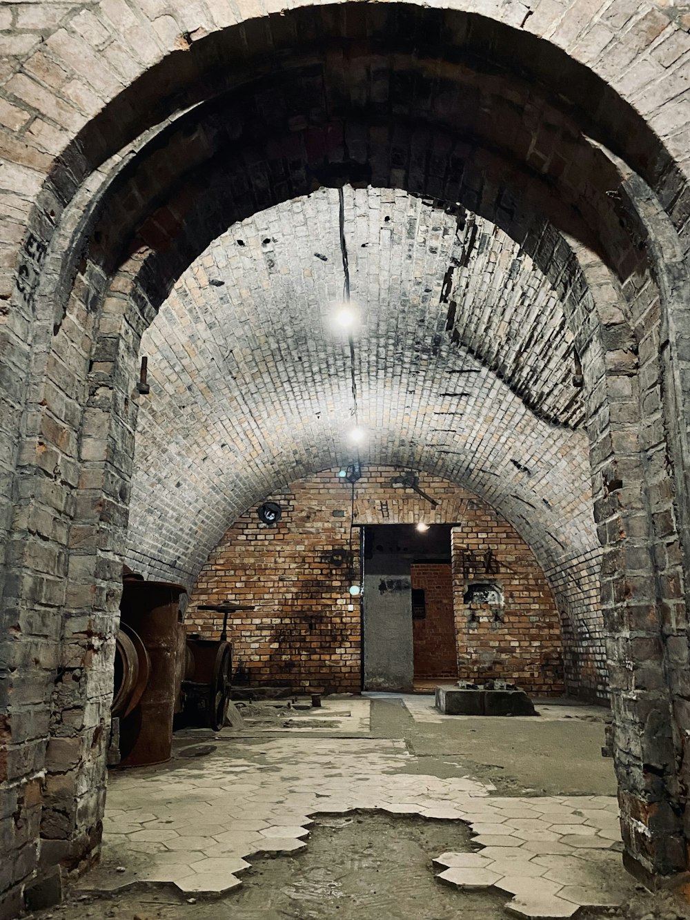 an old brick tunnel with a door and brick walls