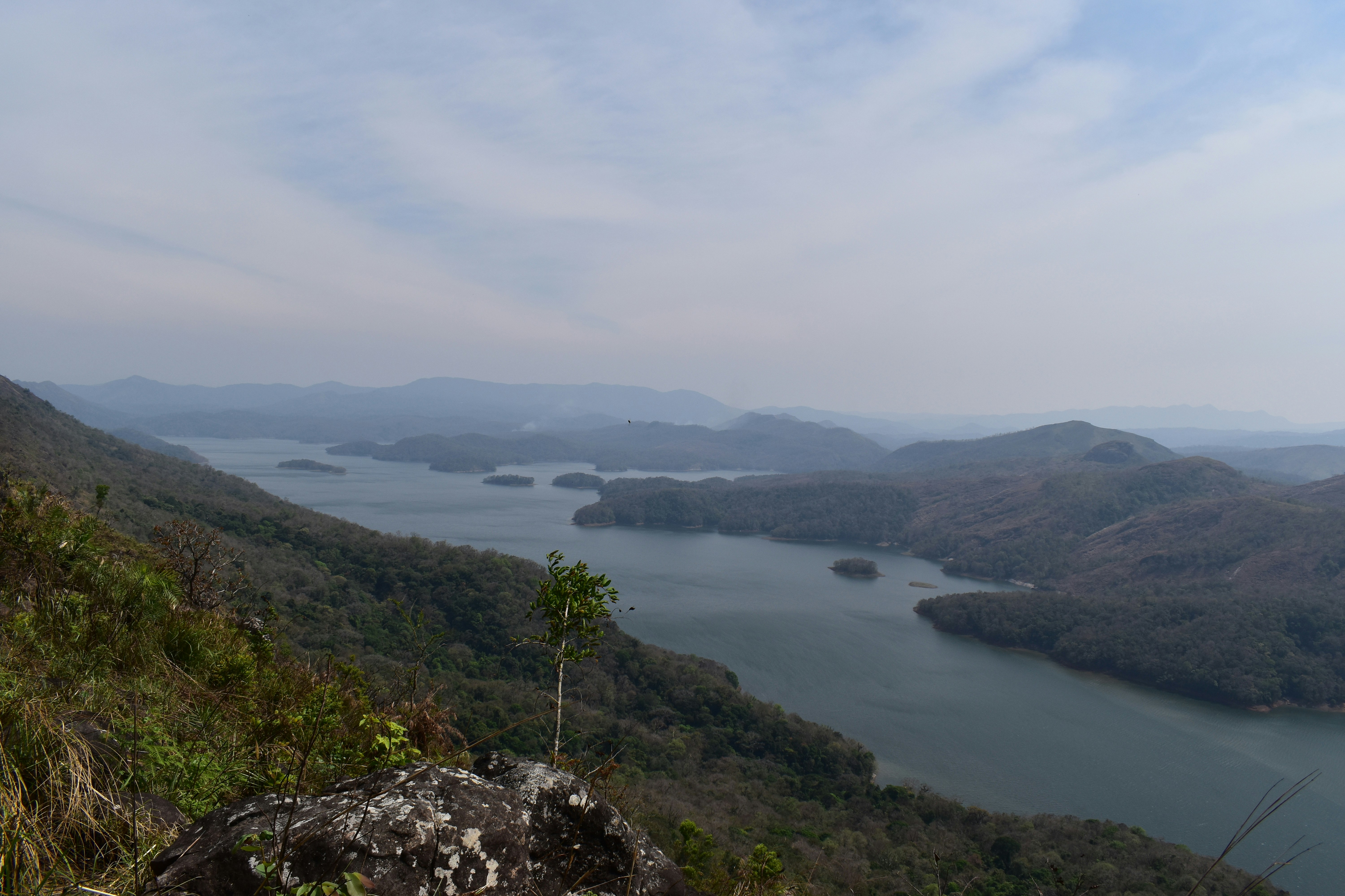 a large body of water surrounded by mountains, 