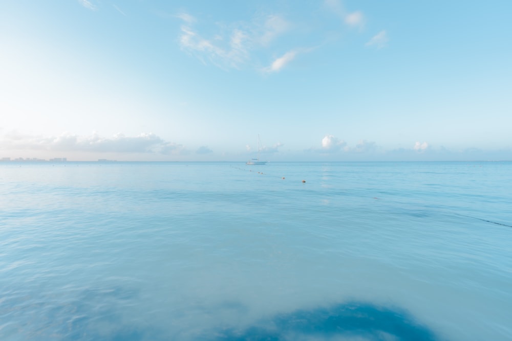 a body of water with a boat in the distance