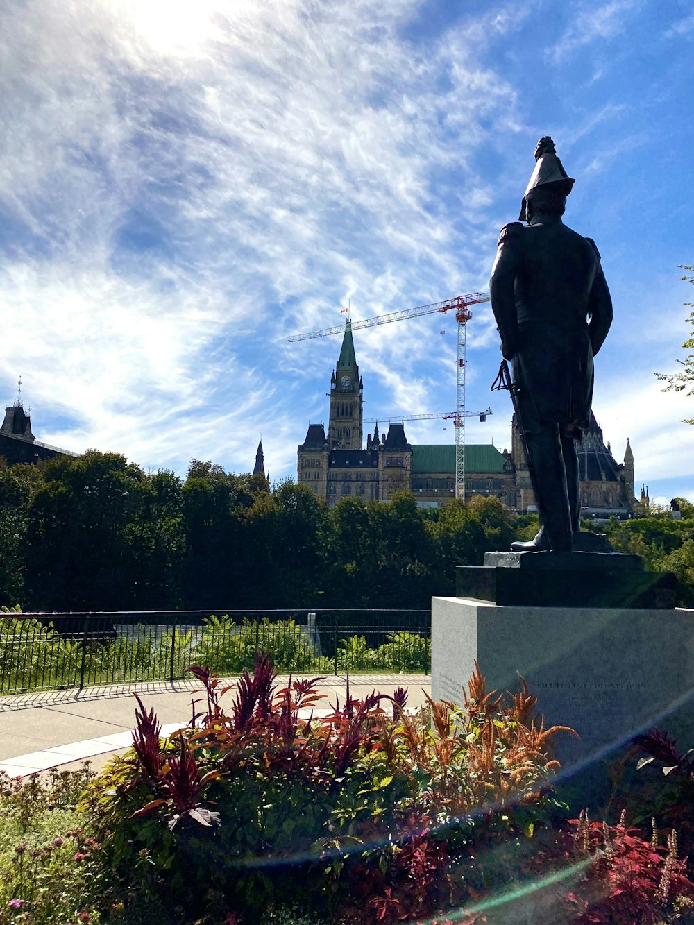 a statue of a man in front of a castle