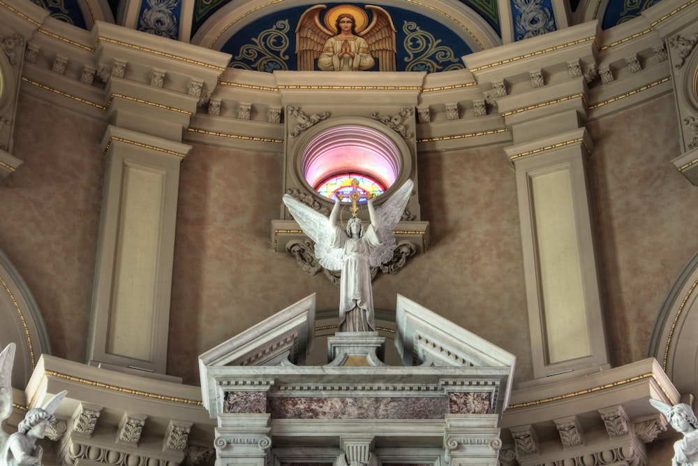 a statue of an angel on top of a building