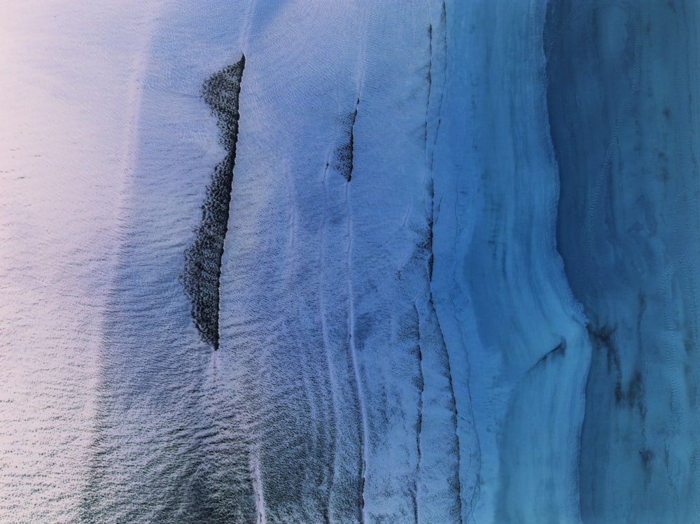 an aerial view of a glacier with snow on the ground