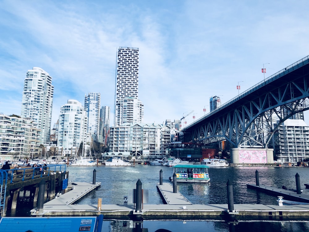 a bridge over a body of water with a city in the background