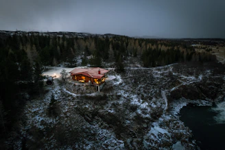 an aerial view of a house in the middle of a forest