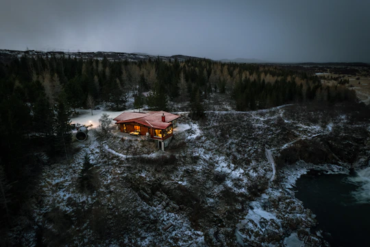 an aerial view of a house in the middle of a forest