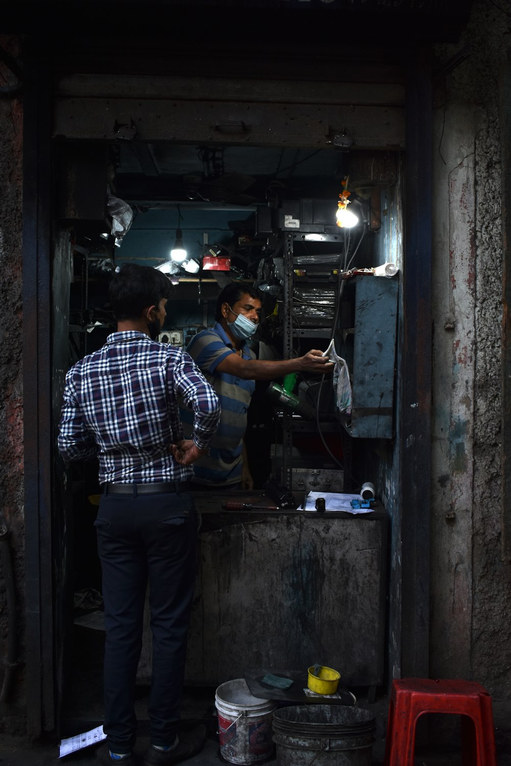 a man standing next to another man in a room