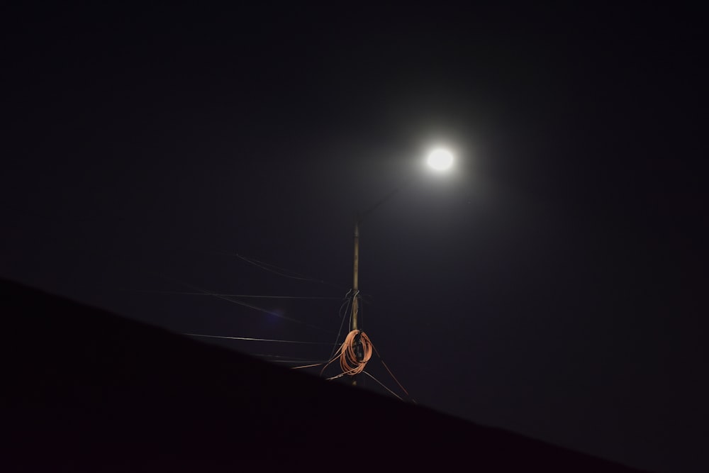 a full moon is seen above a dark sky