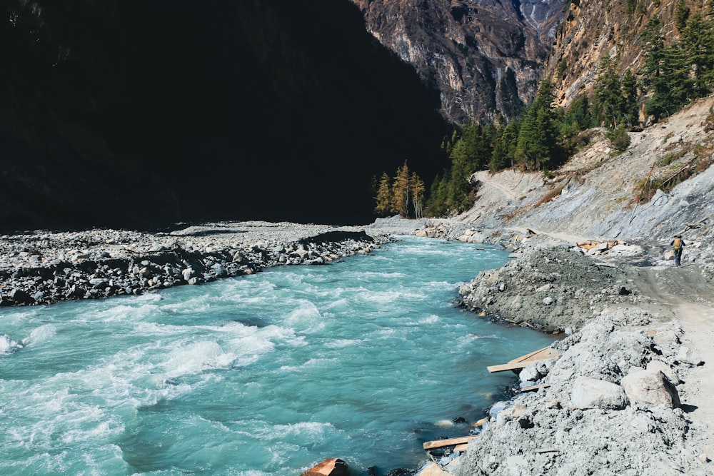 a river running through a valley surrounded by mountains