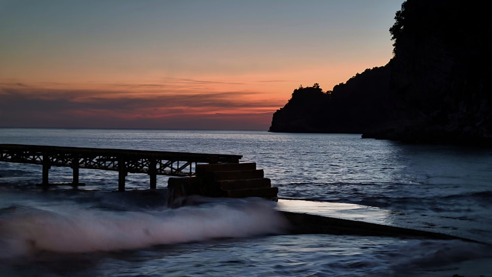 a pier in the middle of a body of water