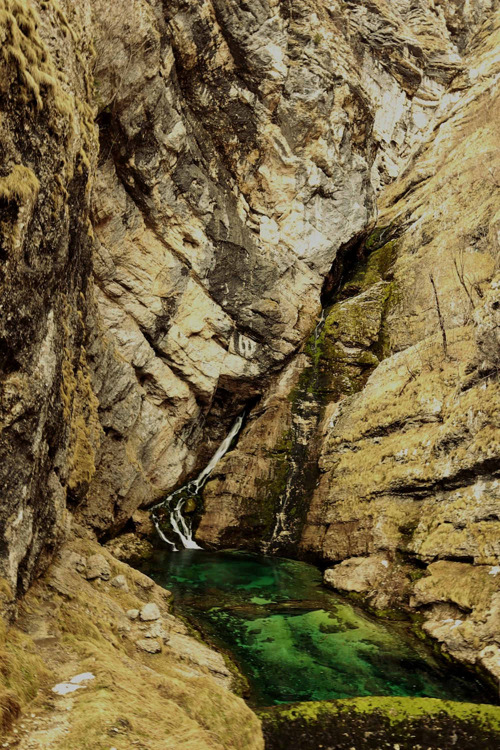 a small waterfall in the middle of a canyon