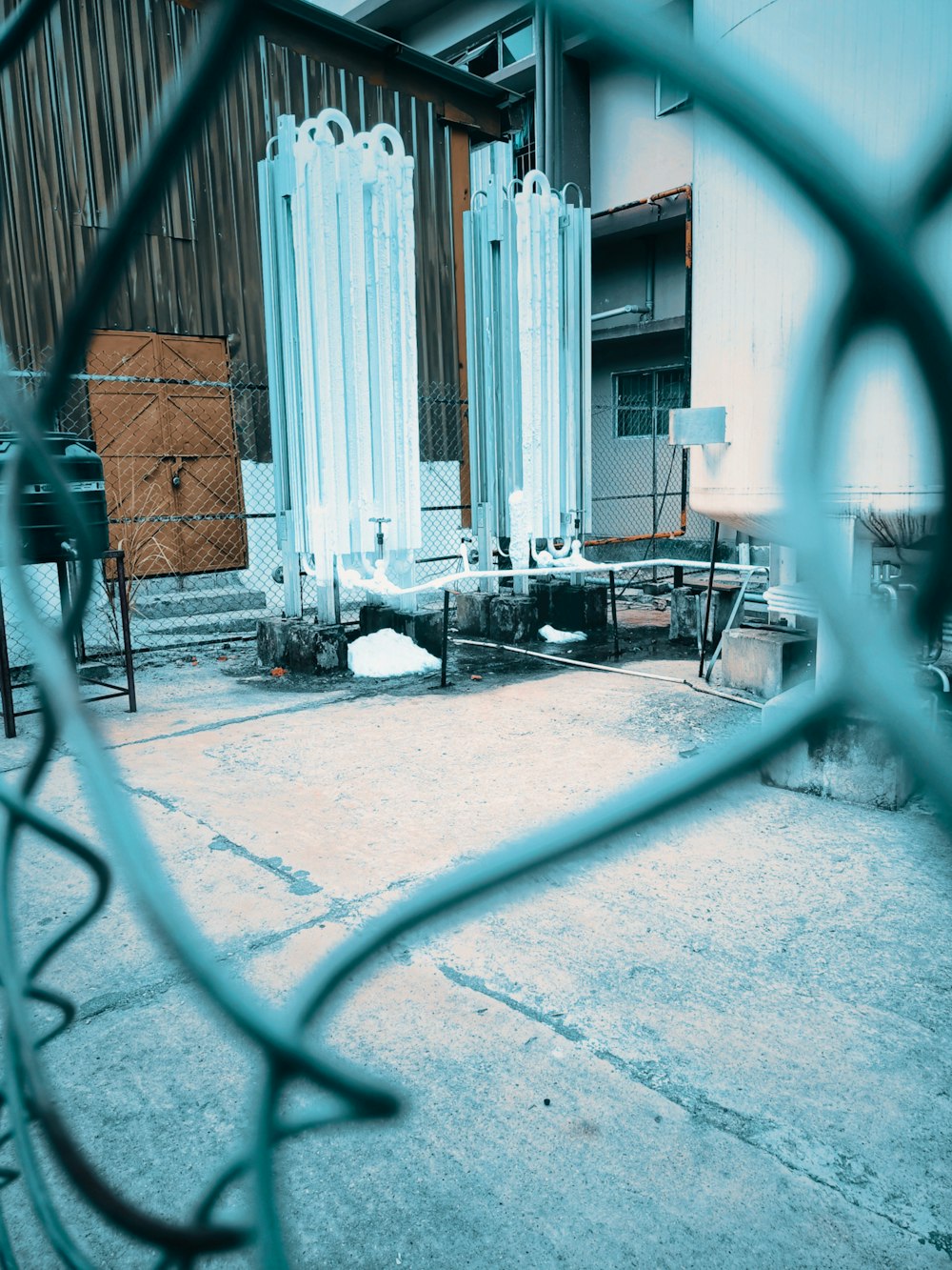 a view through a chain link fence of a building