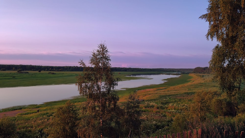 a river running through a lush green countryside