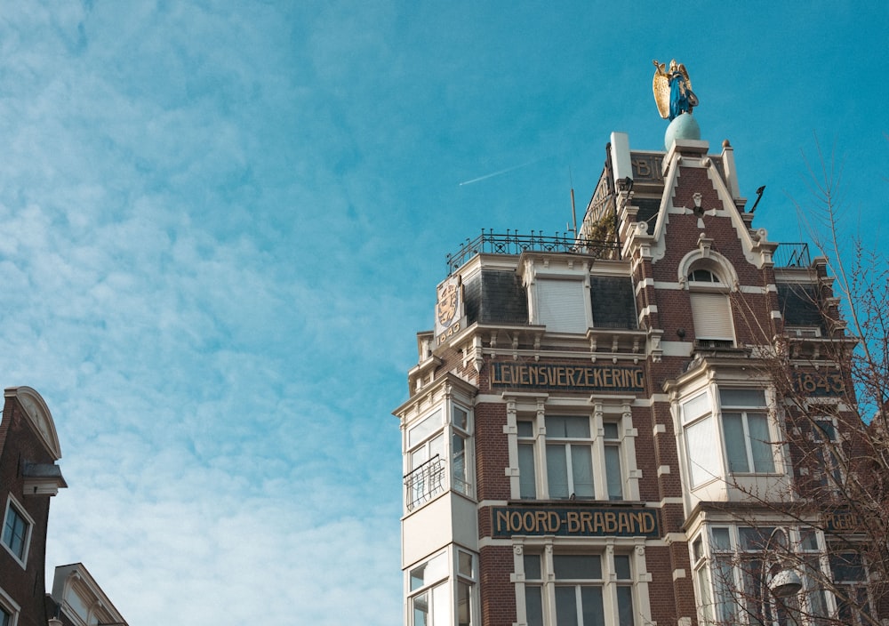 a tall building with a statue on top of it