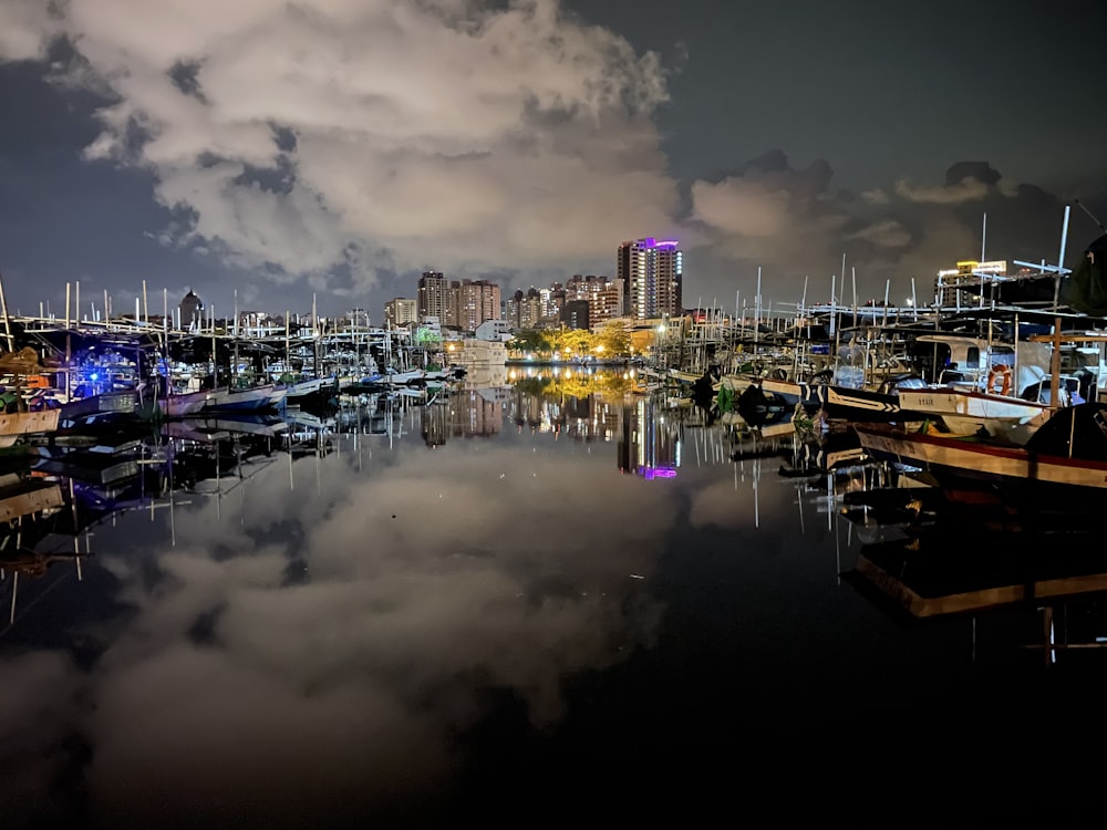 a harbor filled with lots of boats under a cloudy sky