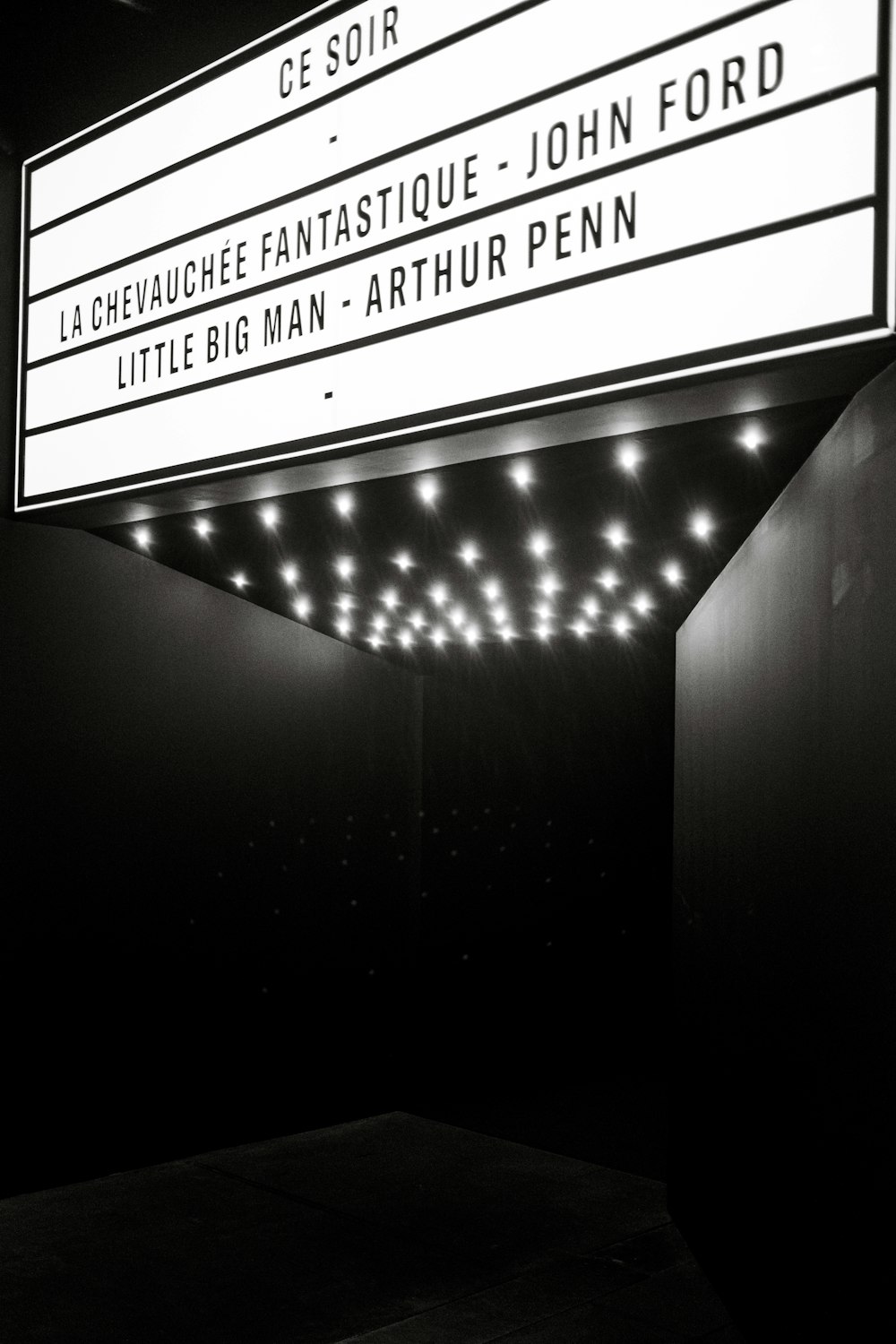 a black and white photo of a marquee sign
