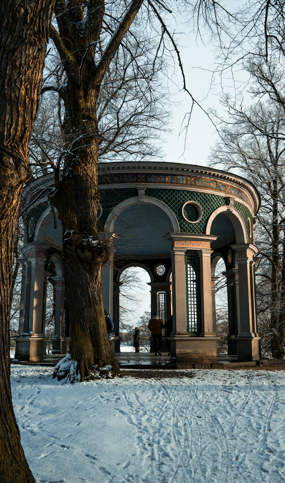 a gazebo in the middle of a snowy park
