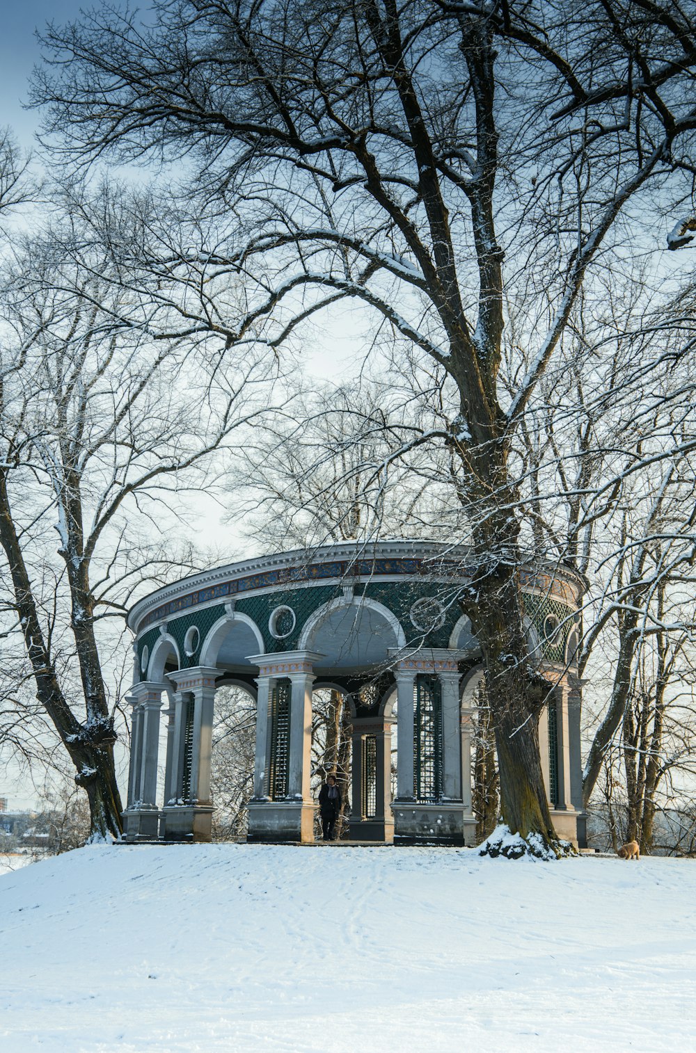 a gazebo in the middle of a snowy field