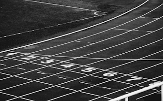 a black and white photo of a running track