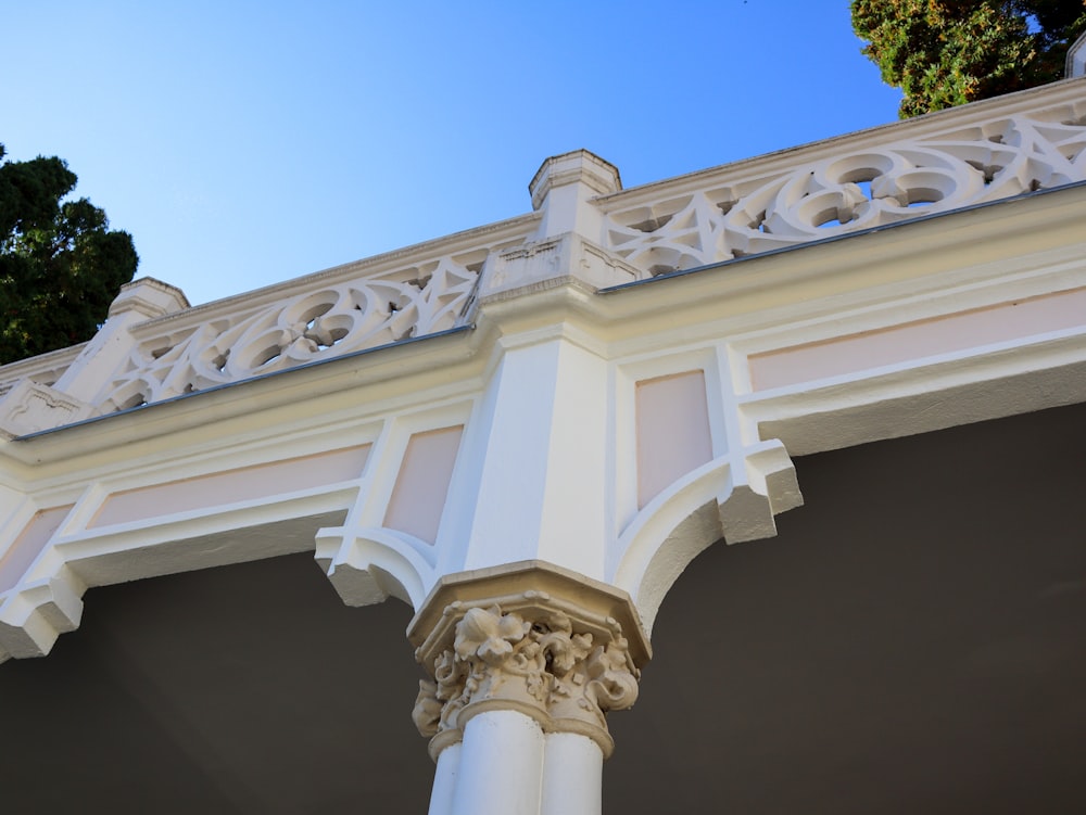 a close up of a white building with a blue sky in the background