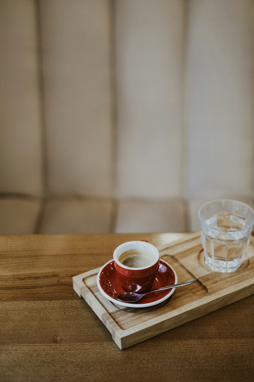 a cup and saucer on a wooden tray