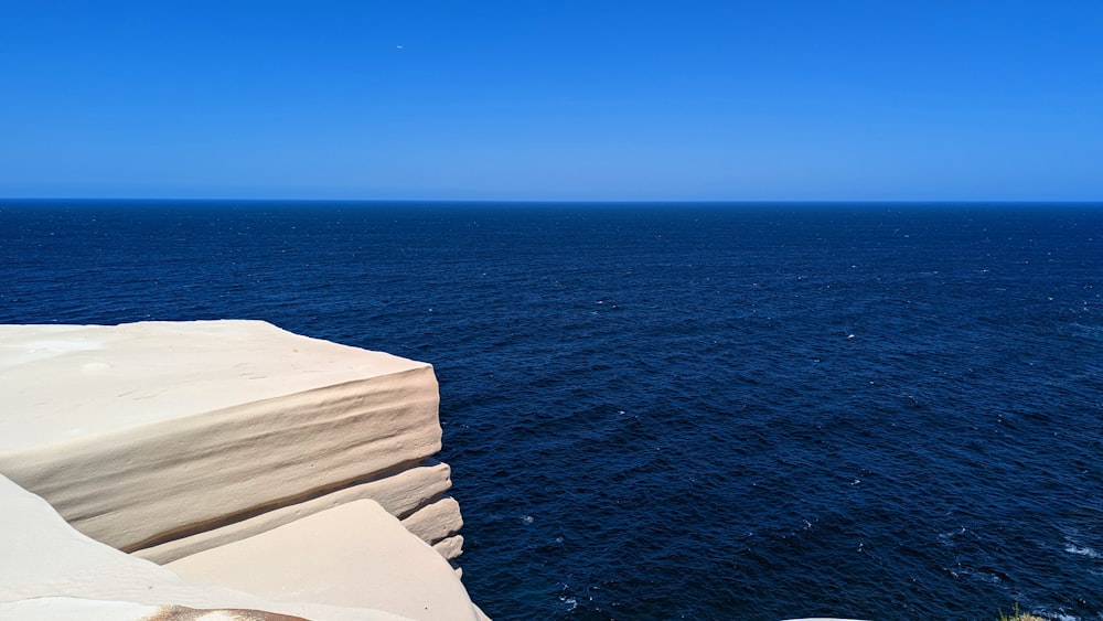 a large body of water sitting next to a cliff