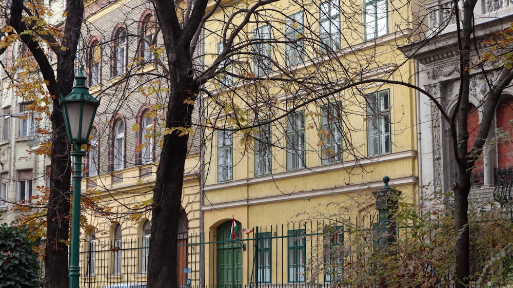 a yellow building with a clock on the front of it