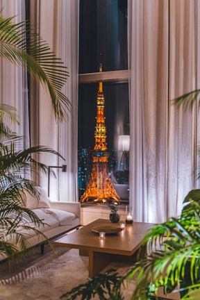 A bright condominium living room with large windows and cozy furnishings.