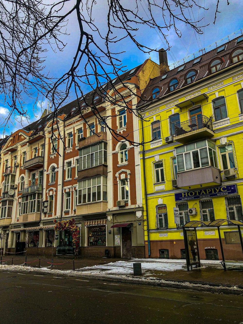 a row of multi - colored buildings on a street corner