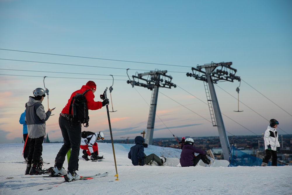 a group of people riding skis on top of a snow covered slope