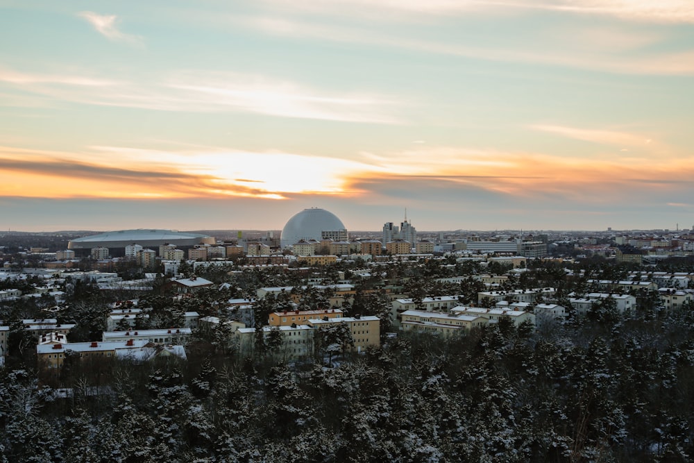 a view of a city at sunset from a hill