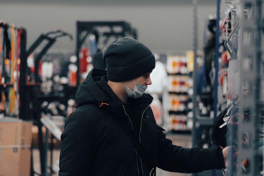 a man wearing a face mask and gloves in a store
