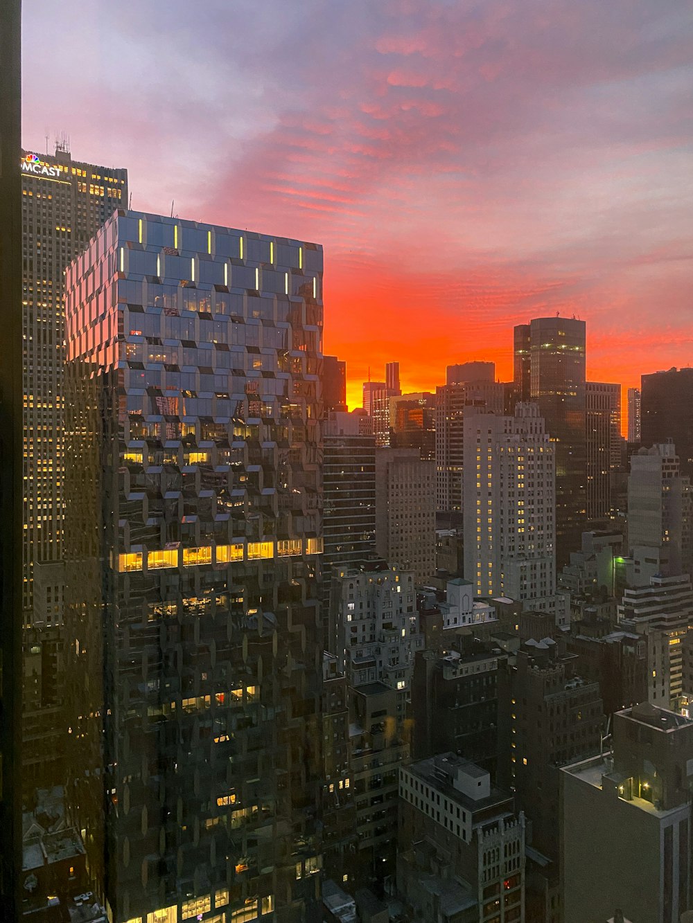 a view of a city at sunset from a high rise building