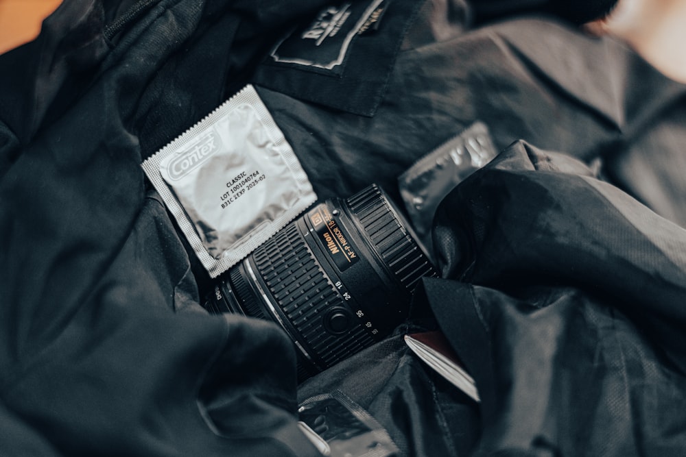 a camera sitting on top of a black jacket