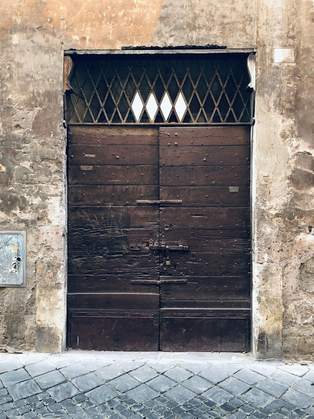 a wooden door with a brick walkway in front of it