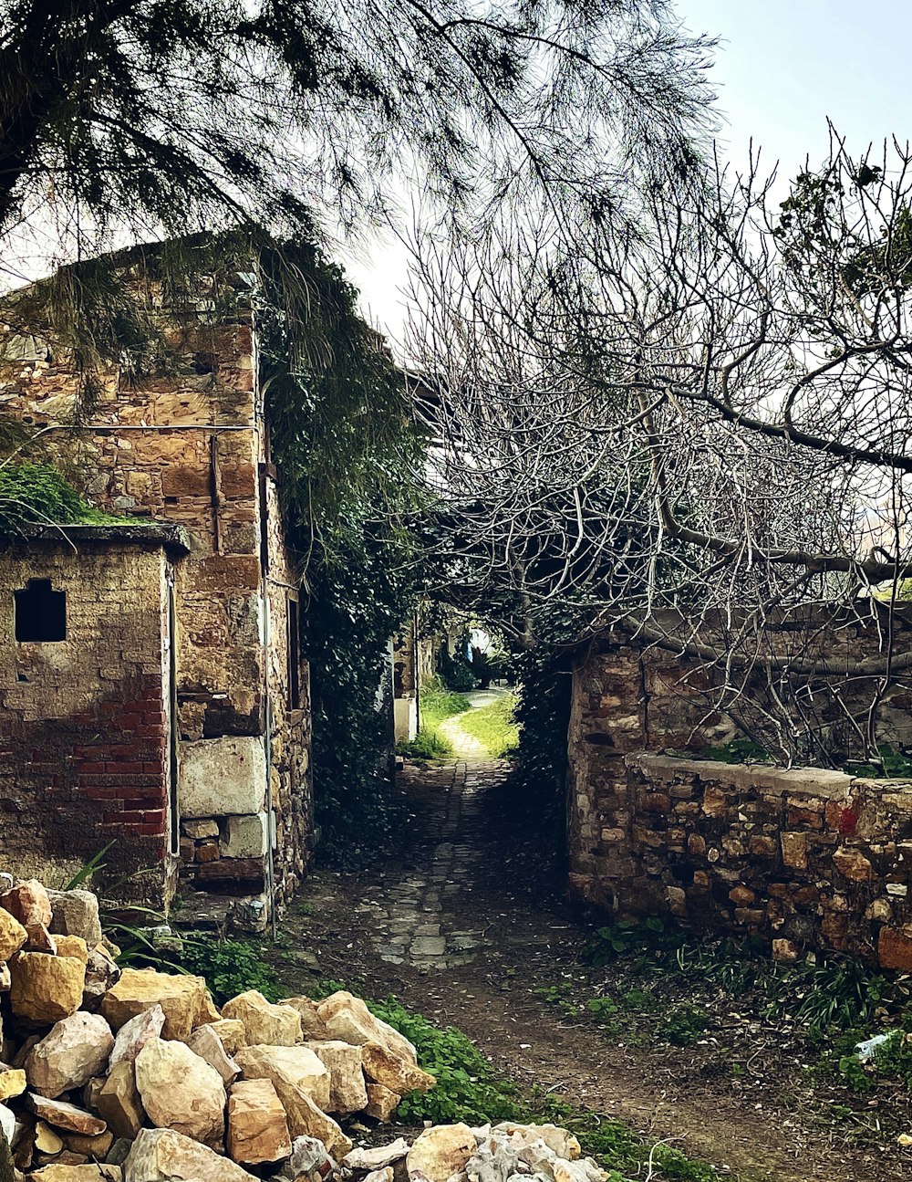 an old brick building with a stone pathway leading to it