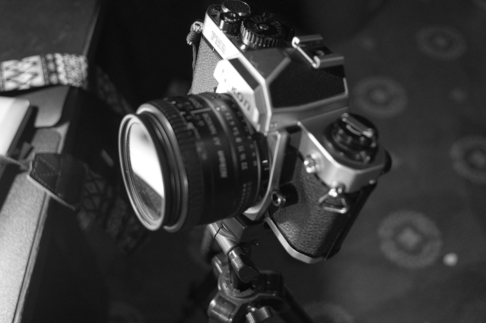 a black and white photo of a camera on a tripod