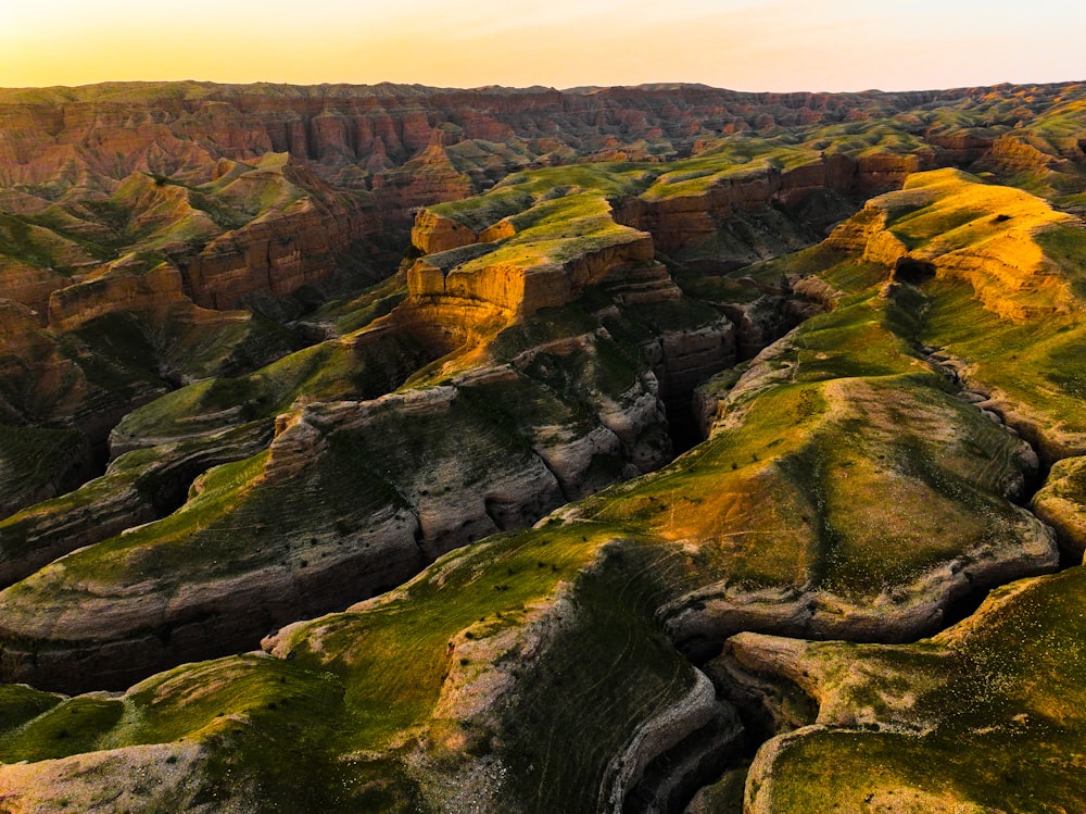 the sun is setting over the rocky terrain