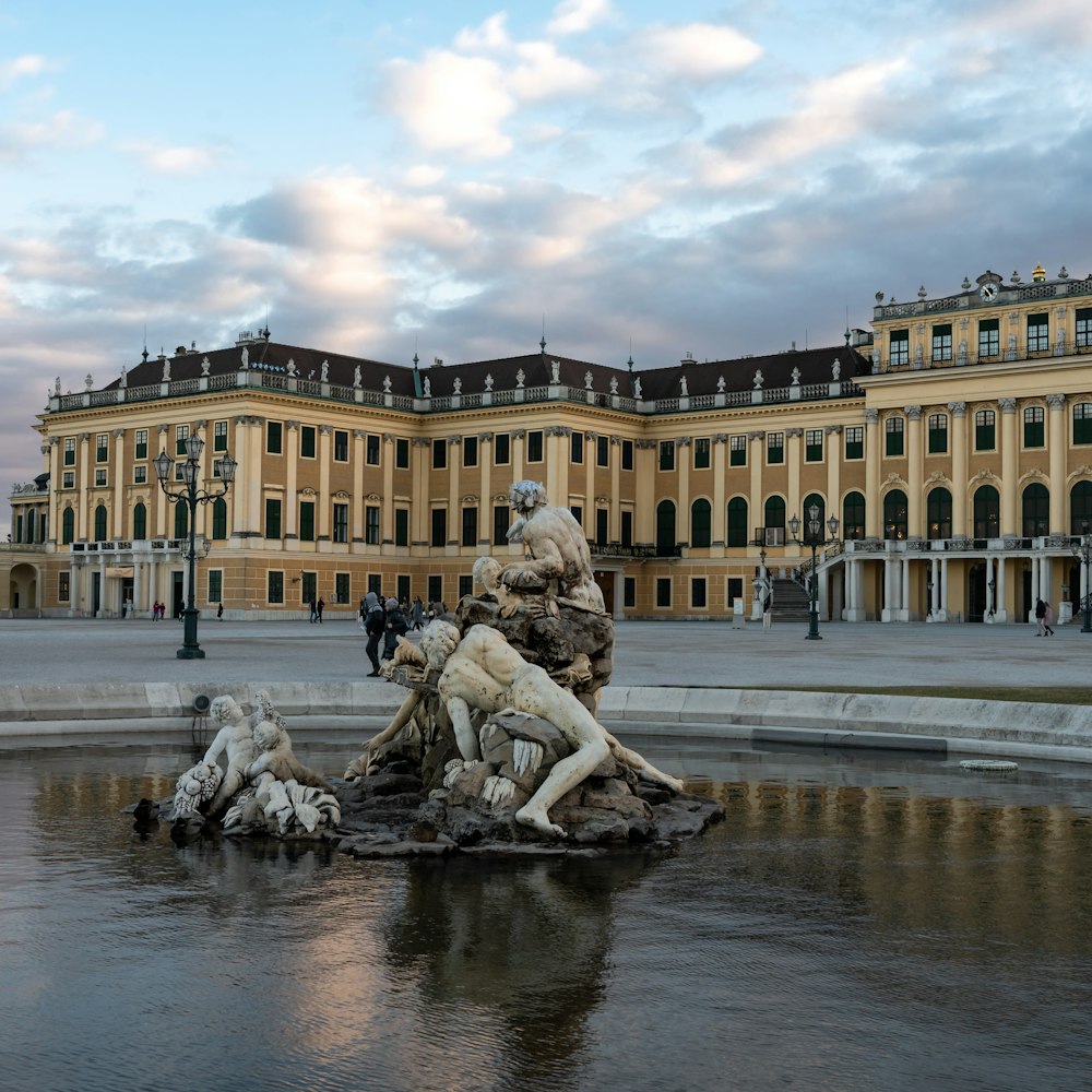 a large building with a fountain in front of it