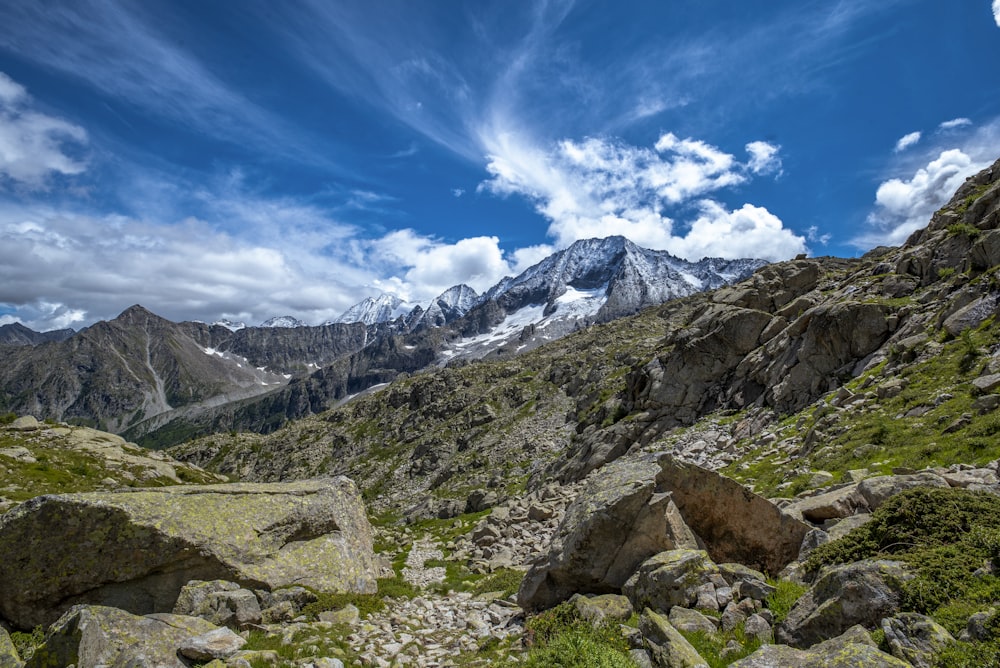 a view of a mountain range with rocks and grass