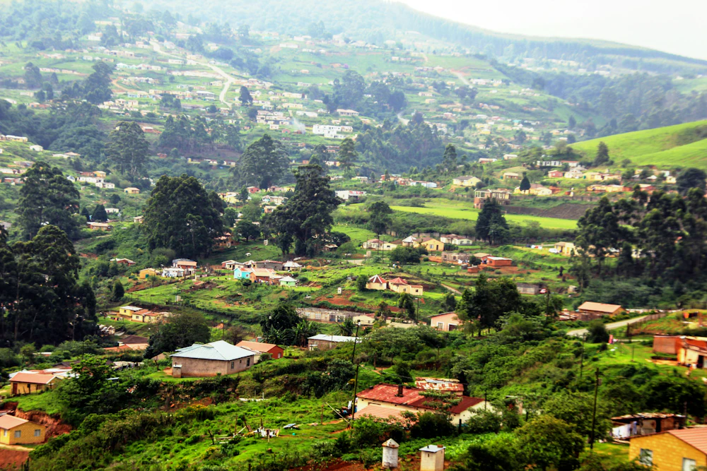 A small rural village nestled on a green hillside in South Africa