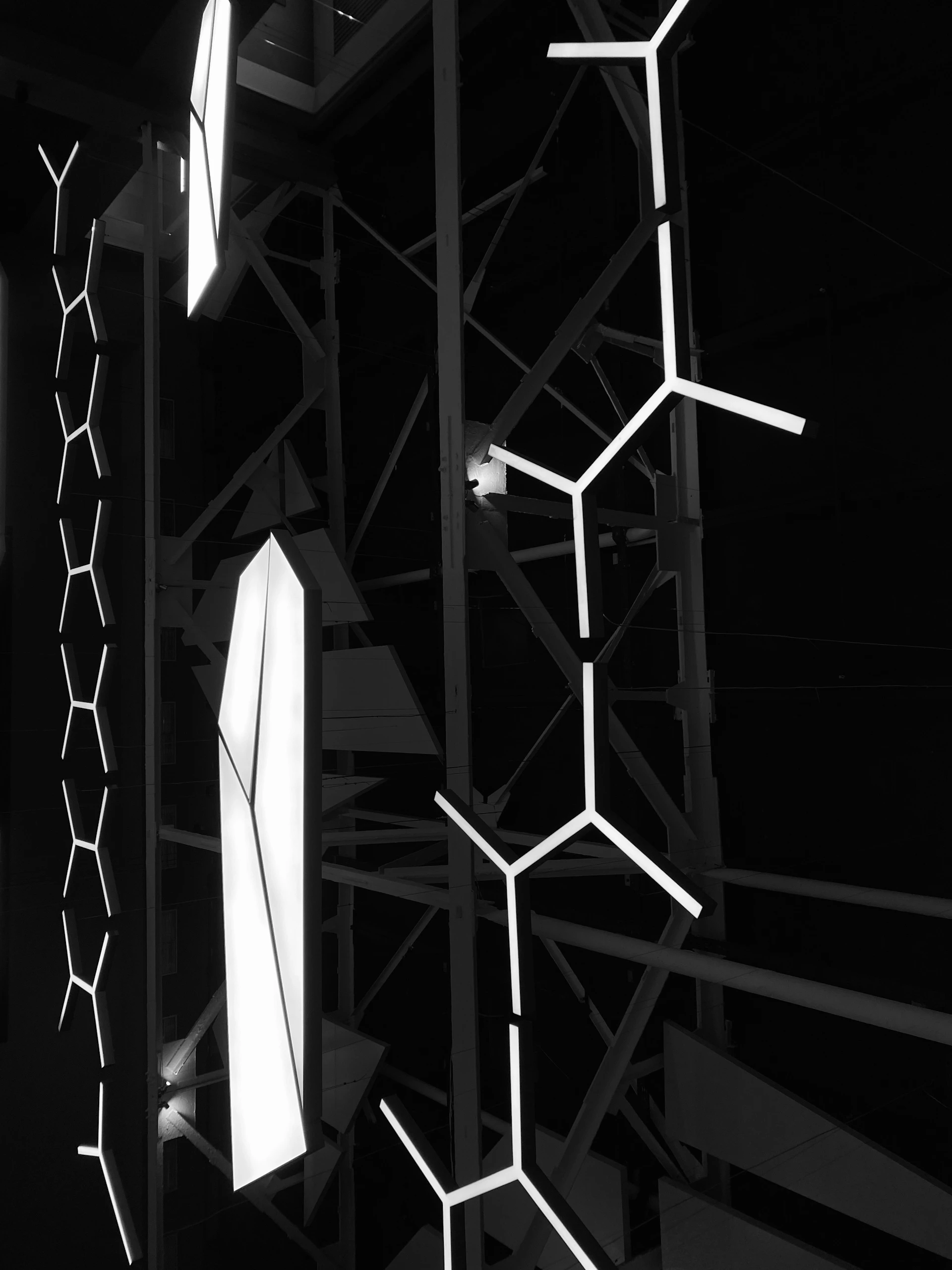 a black and white photo of a building with a bunch of lights on it