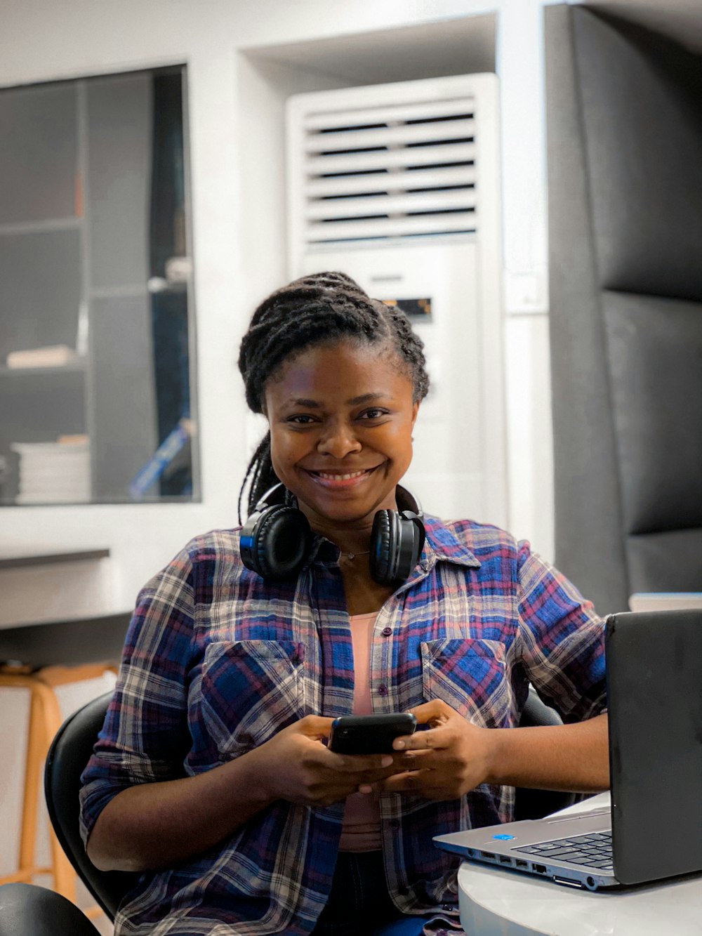 a woman sitting in front of a laptop computer