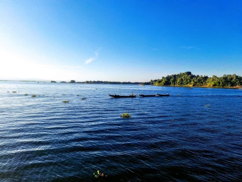 a large body of water with boats floating on top of it