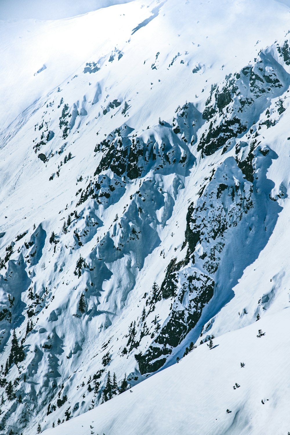 a man riding skis down the side of a snow covered mountain